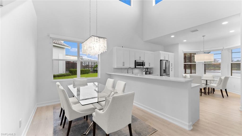 6172 Dogleg Drive Naples, FL 34113 - Photo 18 of 45 a view of a dining room with furniture and a chandelier