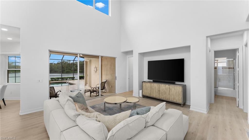6172 Dogleg Drive Naples, FL 34113 - Photo 20 of 45 a living room with furniture and a flat screen tv