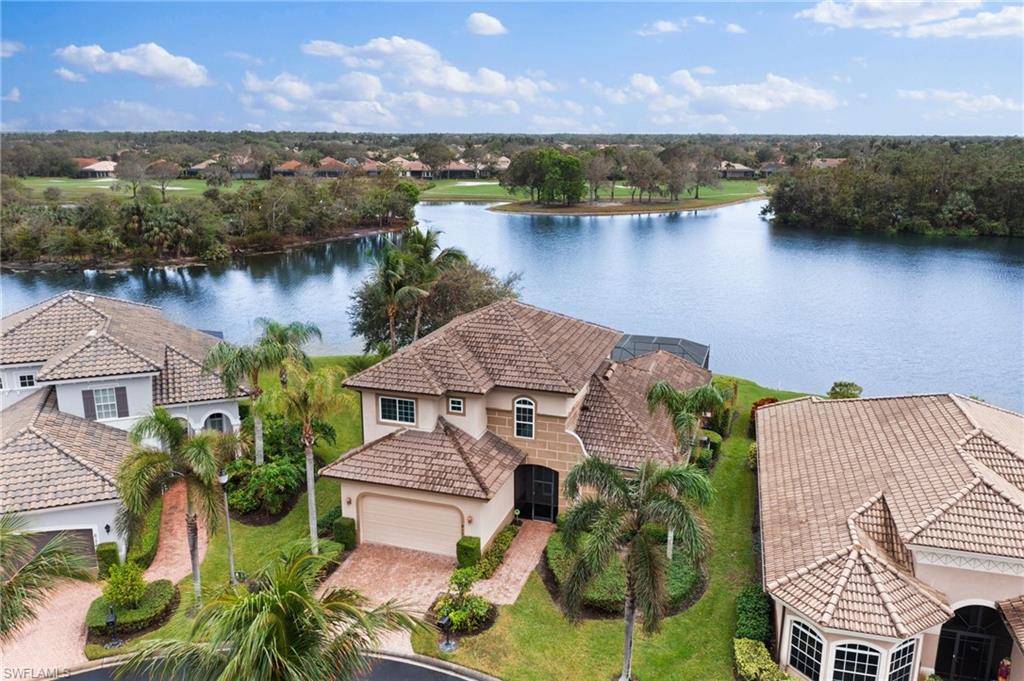 6172 Dogleg Drive Naples, FL 34113 - Photo 2 of 45 an aerial view of a house with a lake view
