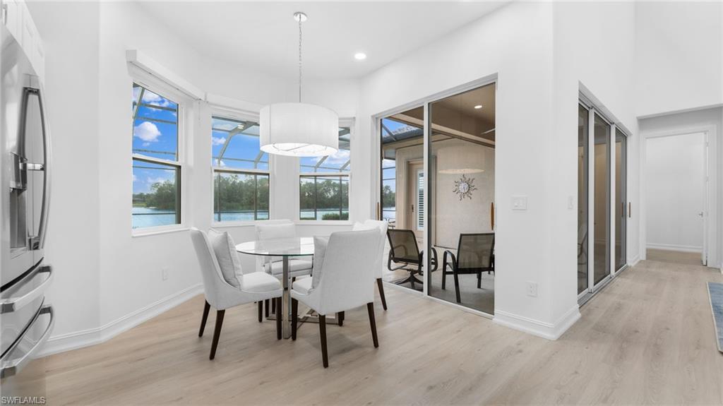 6172 Dogleg Drive Naples, FL 34113 - Photo 22 of 45 a view of a dining room with furniture window and wooden floor