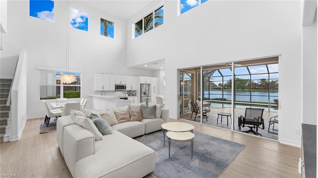 6172 Dogleg Drive Naples, FL 34113 - Photo 23 of 45 a living room with furniture and a large window