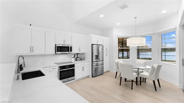 a kitchen with stainless steel appliances a stove a sink and a refrigerator