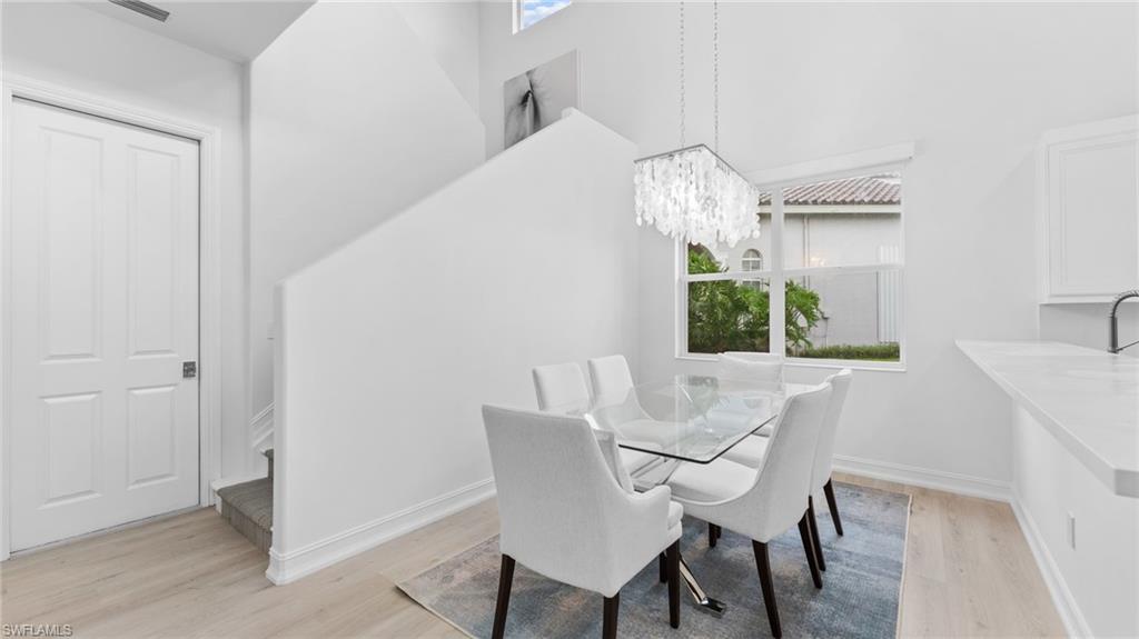 6172 Dogleg Drive Naples, FL 34113 - Photo 29 of 45 a view of a dining room with furniture and chandelier