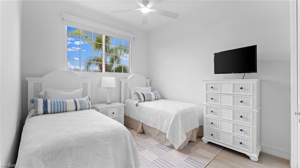 6172 Dogleg Drive Naples, FL 34113 - Photo 30 of 45 a bedroom with two beds and a flat screen tv