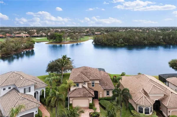 an aerial view of a house with a lake view