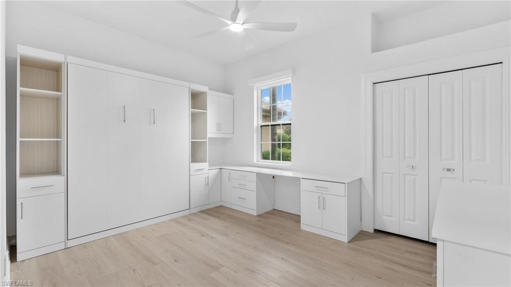 6172 Dogleg Drive Naples, FL 34113 - Photo 32 of 45 a view of a kitchen with wooden floor and electronic appliances