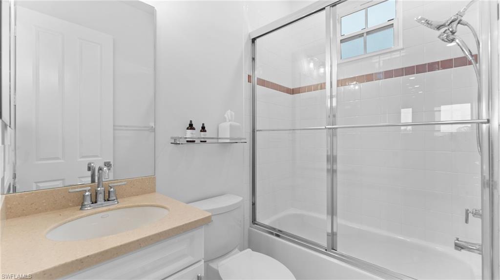 6172 Dogleg Drive Naples, FL 34113 - Photo 34 of 45 a bathroom with a granite countertop sink toilet and shower