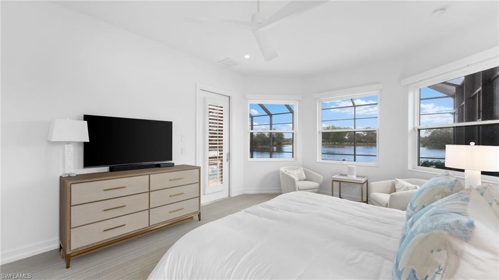 6172 Dogleg Drive Naples, FL 34113 - Photo 37 of 45 a bedroom with a bed and a flat screen tv