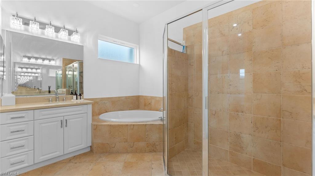 6172 Dogleg Drive Naples, FL 34113 - Photo 39 of 45 a bathroom with a granite countertop sink a toilet a mirror and shower