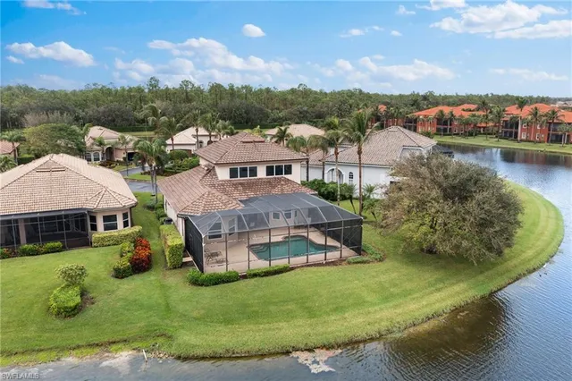 an aerial view of a house with a garden and lake view