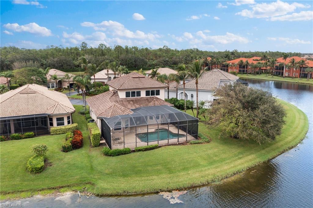 6172 Dogleg Drive Naples, FL 34113 - Photo 4 of 45 an aerial view of a house with a garden and lake view