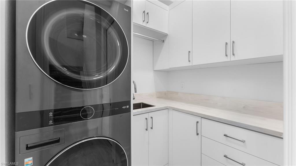 6172 Dogleg Drive Naples, FL 34113 - Photo 41 of 45 a close view of utility room with washer and dryer