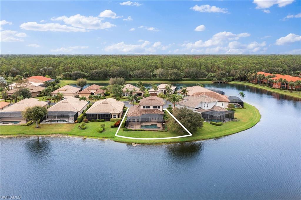 6172 Dogleg Drive Naples, FL 34113 - Photo 6 of 45 a view of a lake with a nearby beach