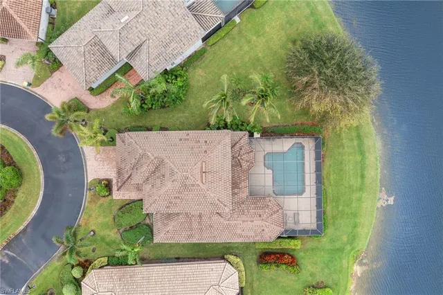 an aerial view of a house with a backyard