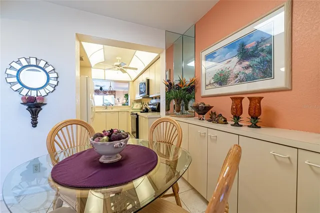 a dining room with furniture a potted plant and a chandelier
