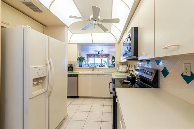 a kitchen with a white cabinets and white appliances