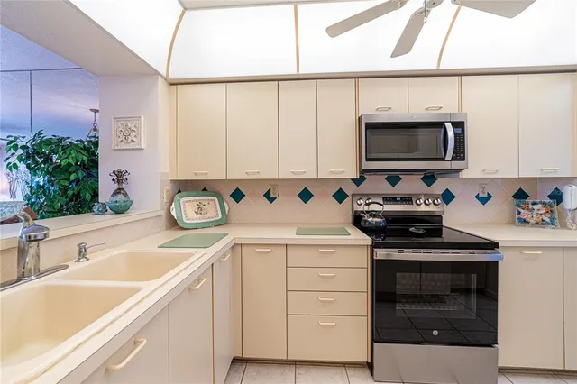 a kitchen with stainless steel appliances a stove a sink and a microwave