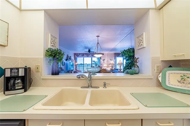 a room with lots of furniture and potted plants