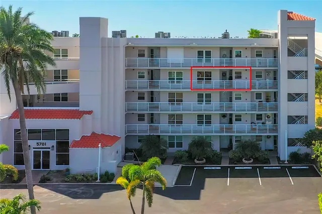 a front view of a building with a garden