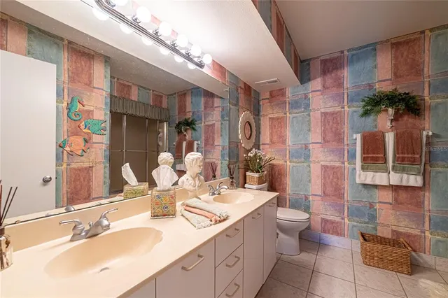 a bathroom with a sink a large mirror and a shower