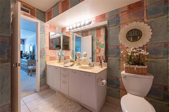 a bathroom with a toilet a sink and a mirror