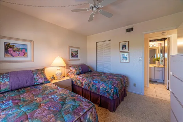 a bedroom with two beds and painting on the wall