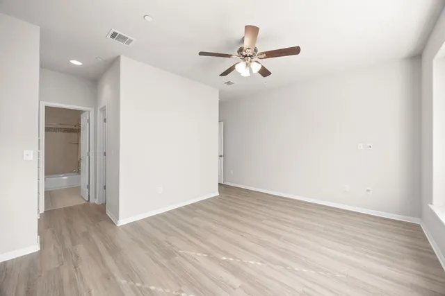a view of a room with wooden floor closet and windows