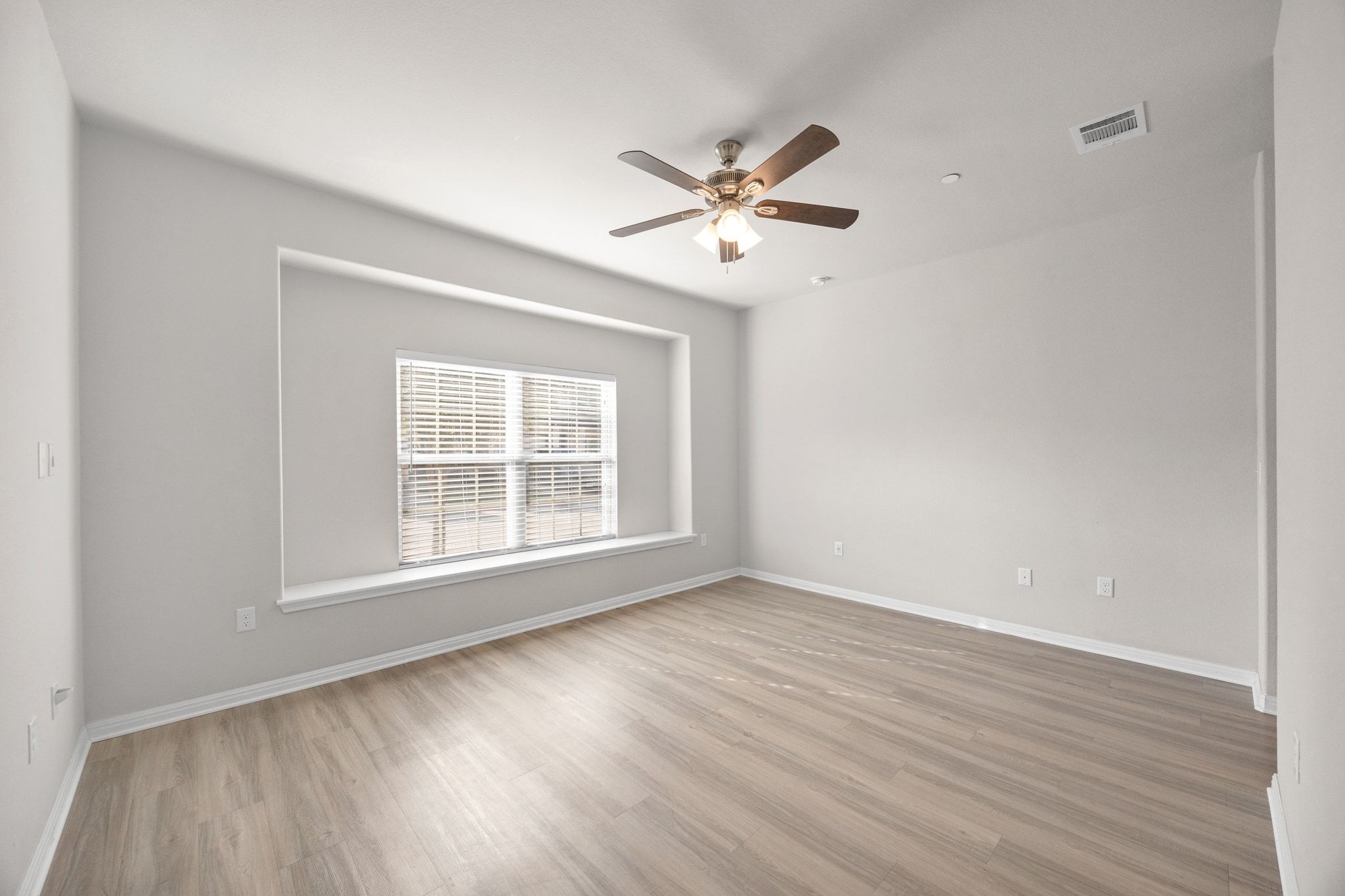 1612 Catalan Road, Unit 201 Austin, TX 78748 - Photo 17 of 35 a view of an empty room with wooden floor and a window