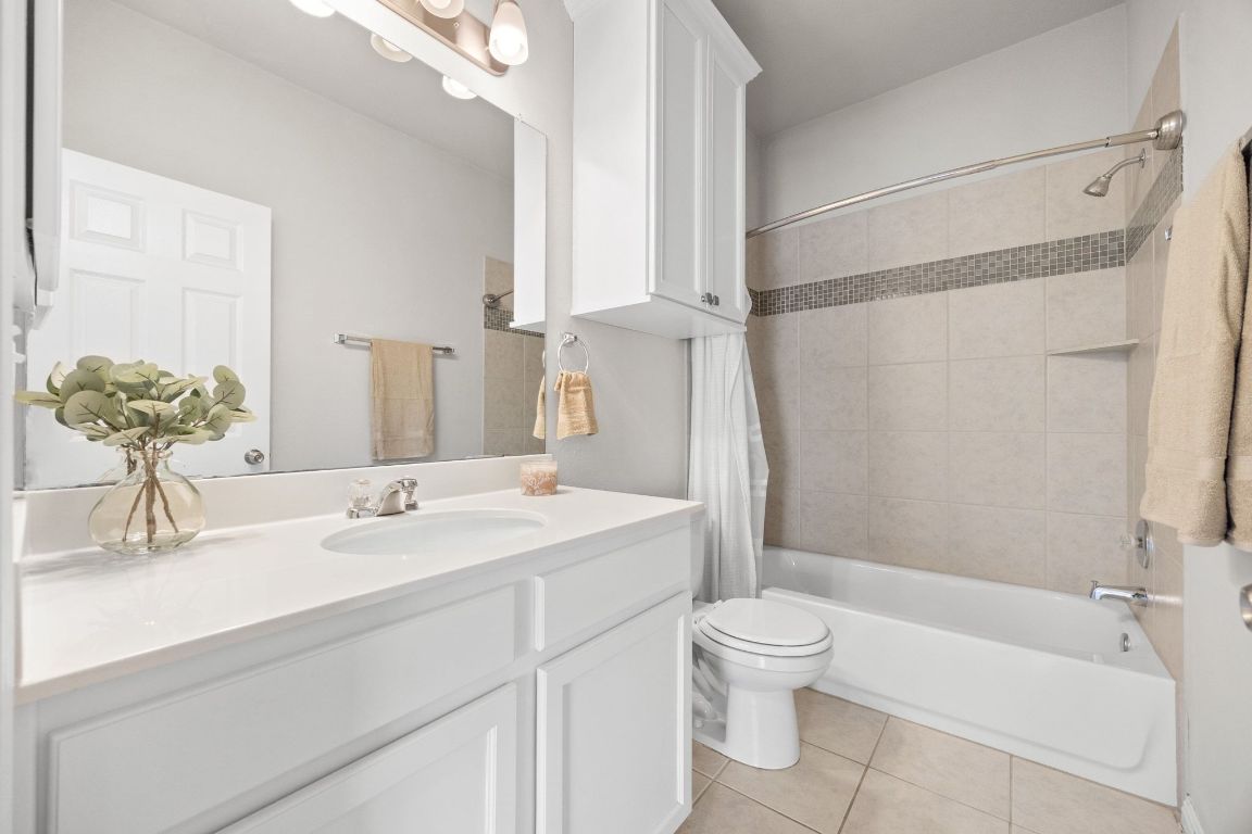 1612 Catalan Road, Unit 201 Austin, TX 78748 - Photo 19 of 35 a bathroom with a granite countertop sink toilet and shower