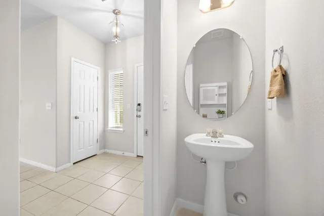 a bathroom with a sink a mirror and shower