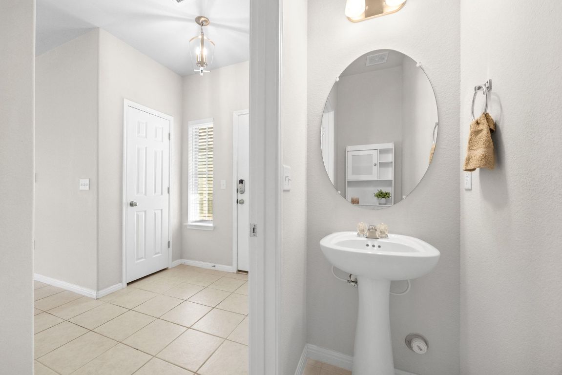 1612 Catalan Road, Unit 201 Austin, TX 78748 - Photo 21 of 35 a bathroom with a sink a mirror and shower