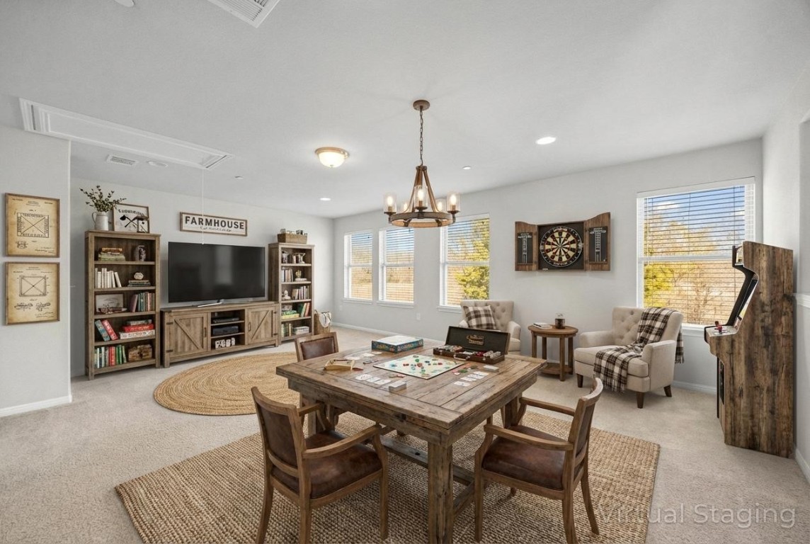 1612 Catalan Road, Unit 201 Austin, TX 78748 - Photo 24 of 35 a living room with furniture a flat screen tv and a chandelier