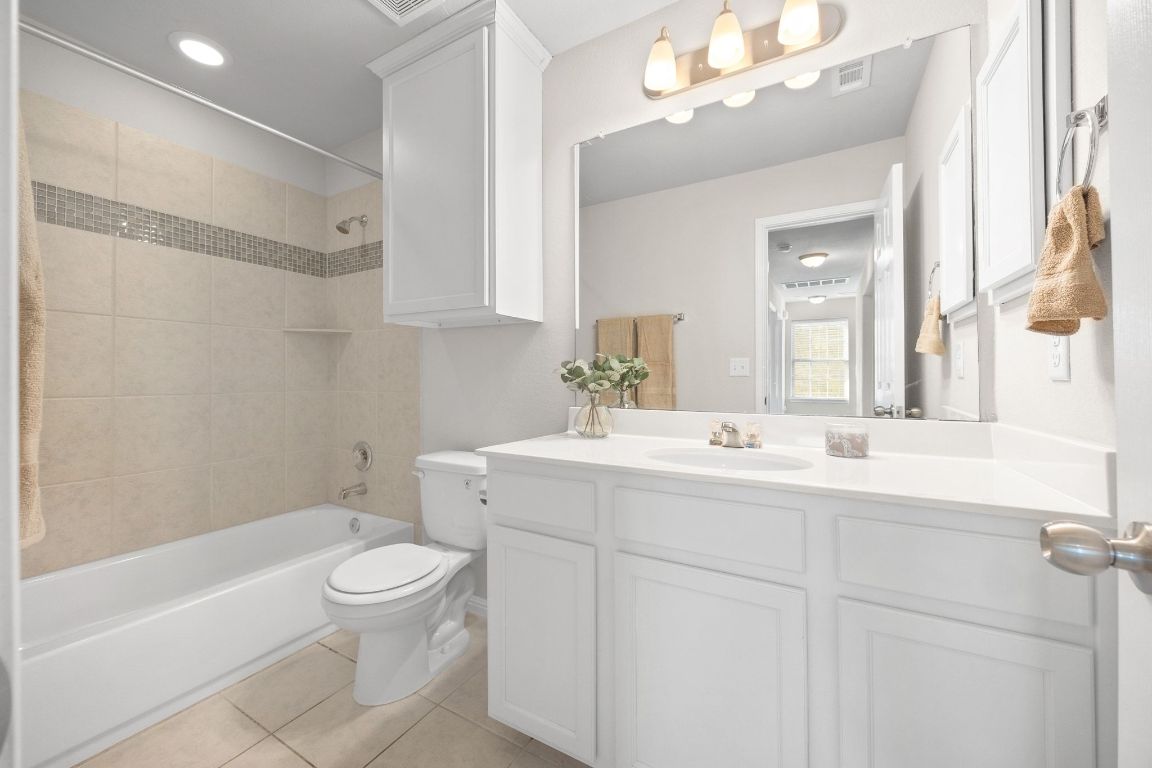 1612 Catalan Road, Unit 201 Austin, TX 78748 - Photo 26 of 35 a bathroom with a sink toilet double vanity and bathtub