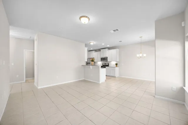 a view of large kitchen with white cabinets