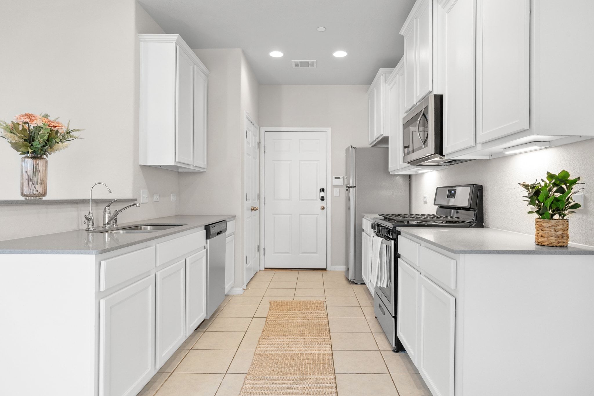 1612 Catalan Road, Unit 201 Austin, TX 78748 - Photo 10 of 35 a kitchen with stainless steel appliances granite countertop a sink and cabinets