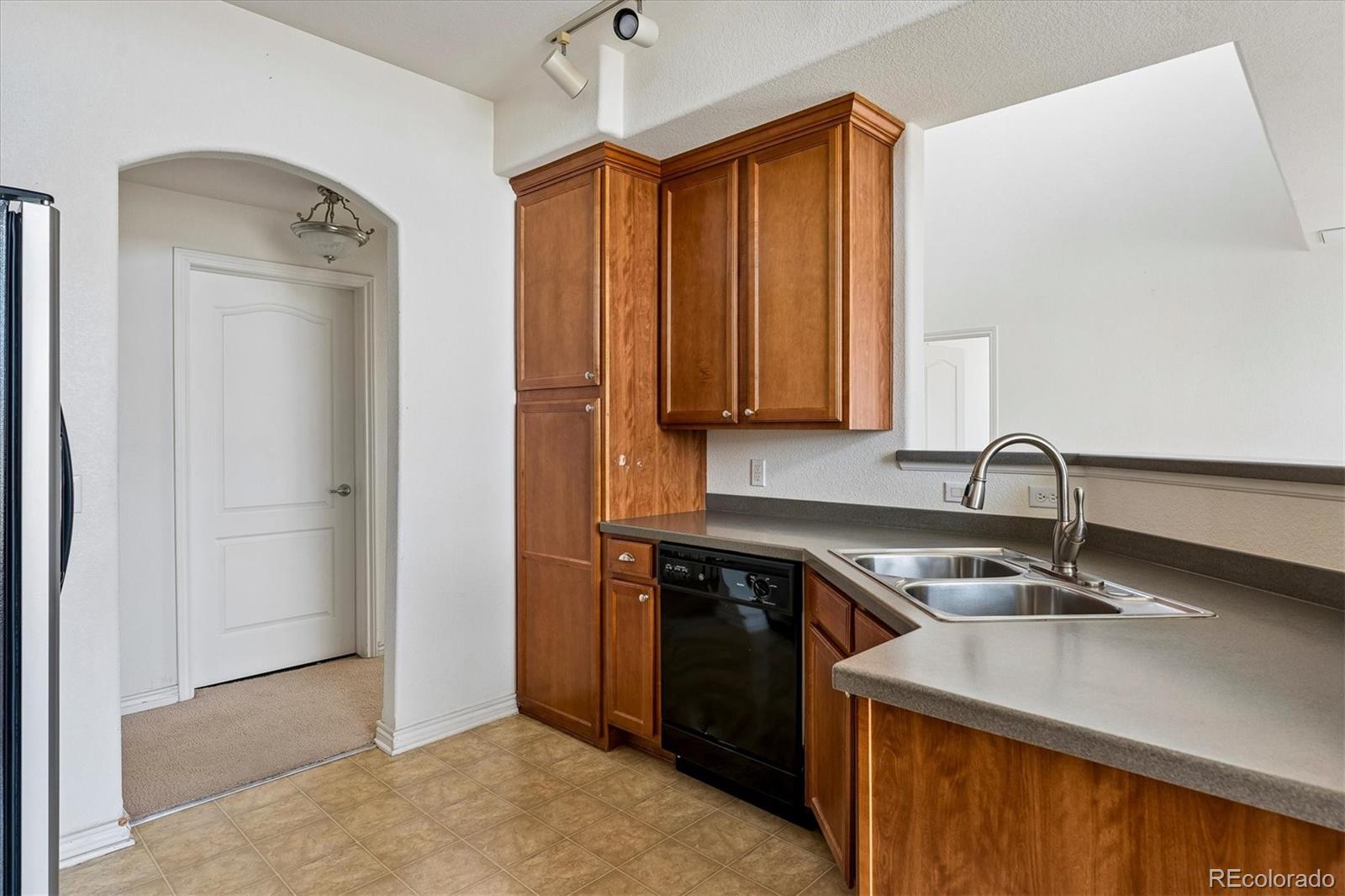 18657 Stroh Road, Unit 4207 Parker, CO 80134 - Photo 12 of 39 a kitchen with stainless steel appliances granite countertop a sink and a refrigerator