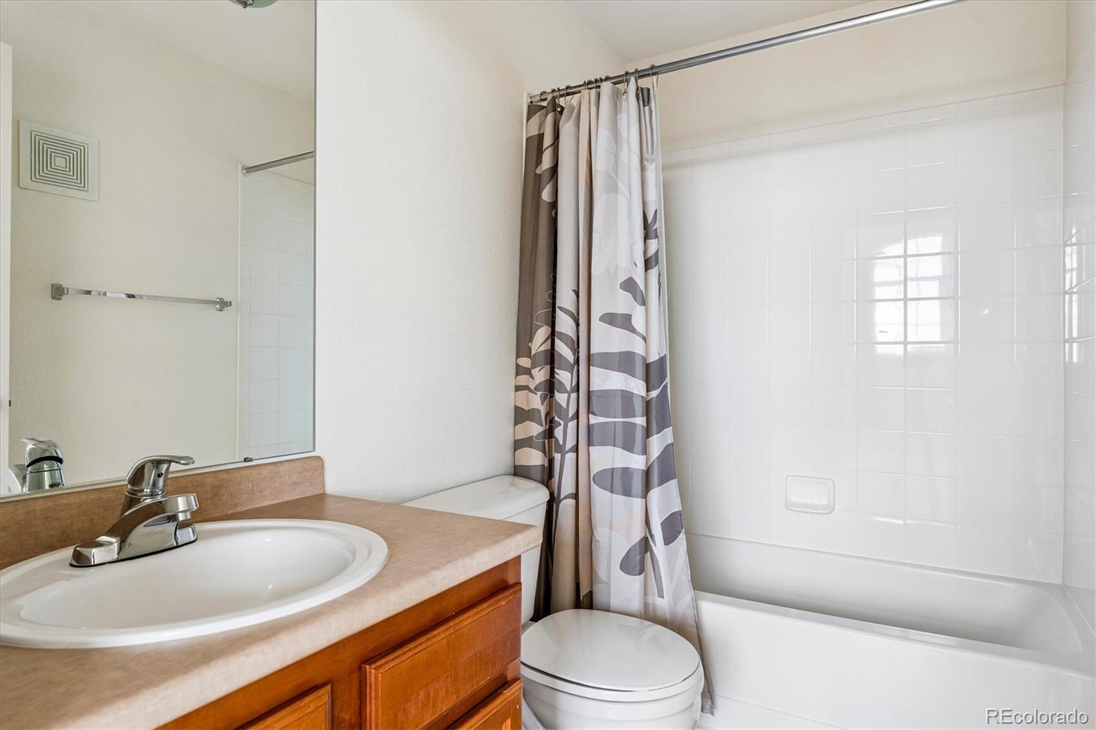 18657 Stroh Road, Unit 4207 Parker, CO 80134 - Photo 26 of 39 a bathroom with a sink toilet and shower