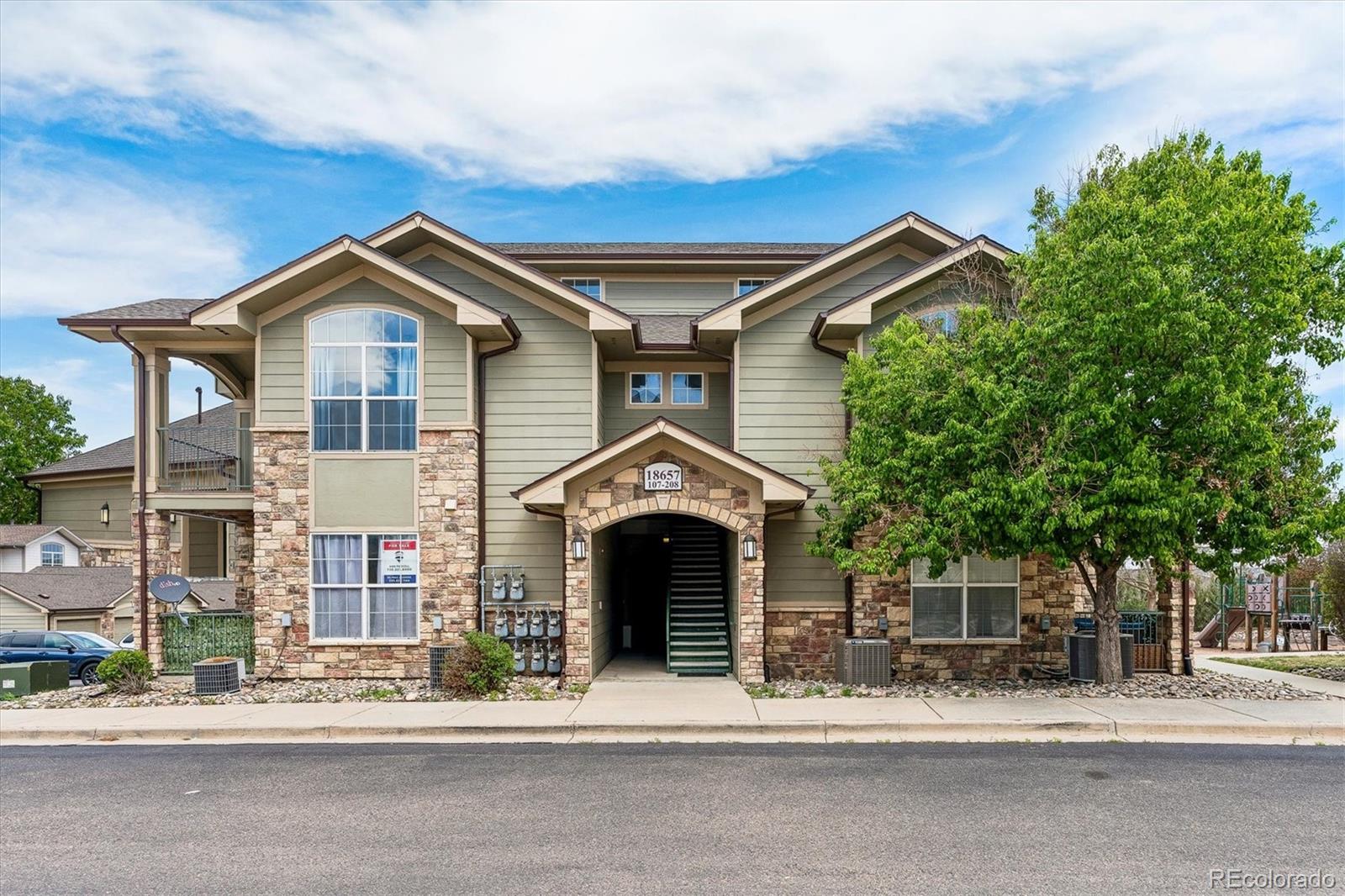 18657 Stroh Road, Unit 4207 Parker, CO 80134 - Photo 29 of 39 a front view of a house with a yard and garage