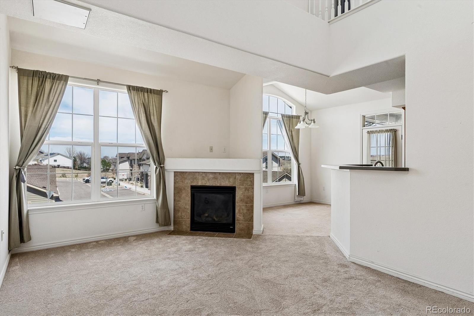 18657 Stroh Road, Unit 4207 Parker, CO 80134 - Photo 8 of 39 a view of an empty room with a fireplace and a window