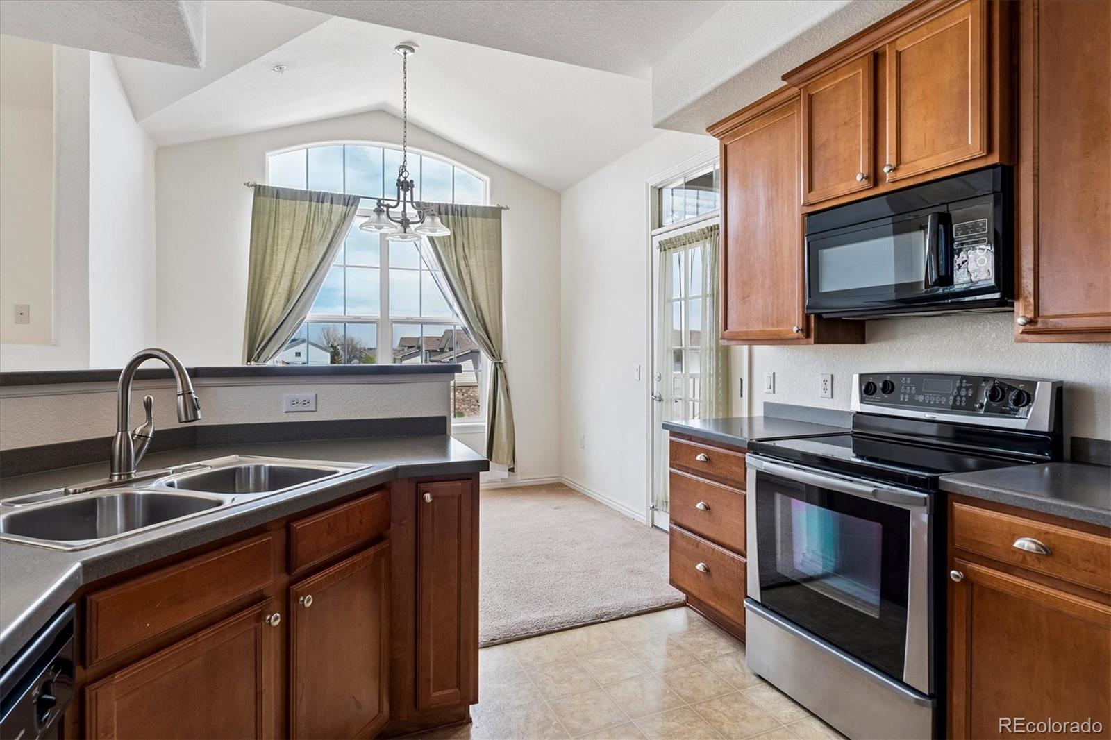 18657 Stroh Road, Unit 4207 Parker, CO 80134 - Photo 10 of 39 a kitchen with stainless steel appliances granite countertop a sink and a stove