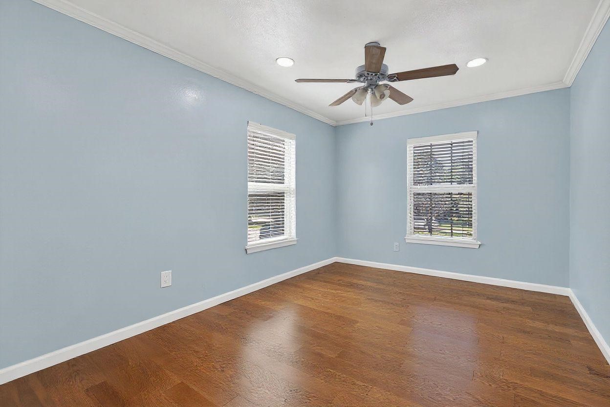 14418 Louetta Road Cypress, TX 77429 - Photo 12 of 39 a view of an empty room with wooden floor and a window