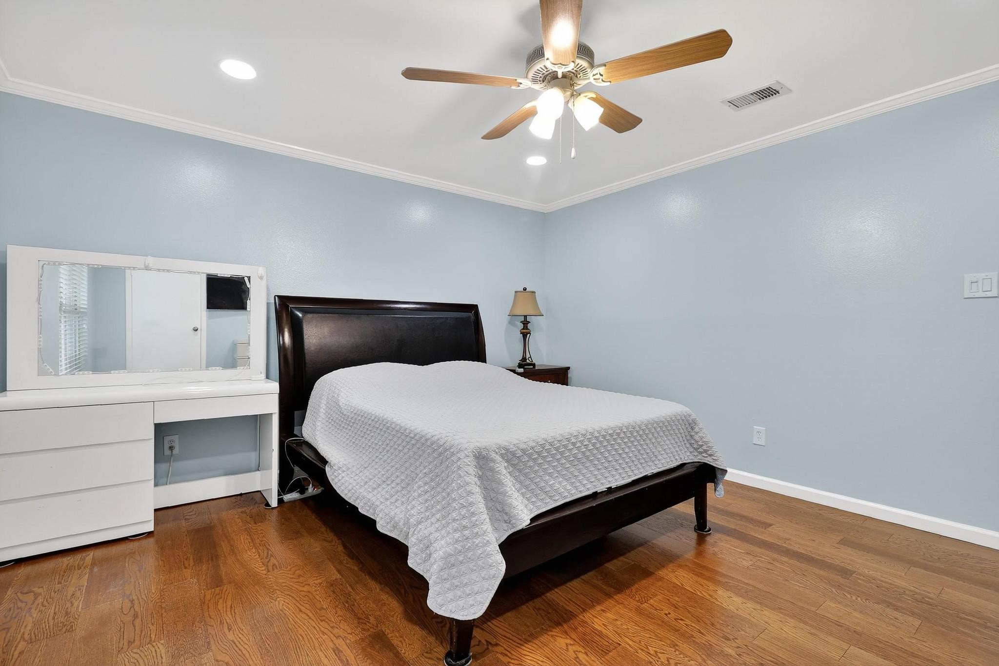 14418 Louetta Road Cypress, TX 77429 - Photo 17 of 39 a bedroom with a bed and a chandelier