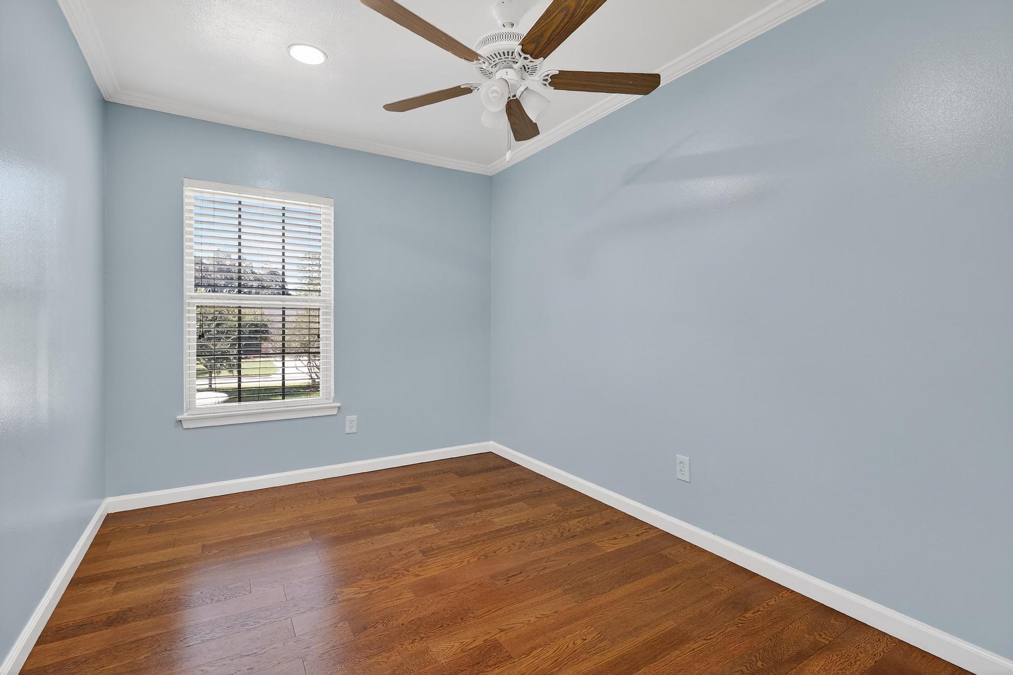 14418 Louetta Road Cypress, TX 77429 - Photo 18 of 39 an empty room with a window and a ceiling fan