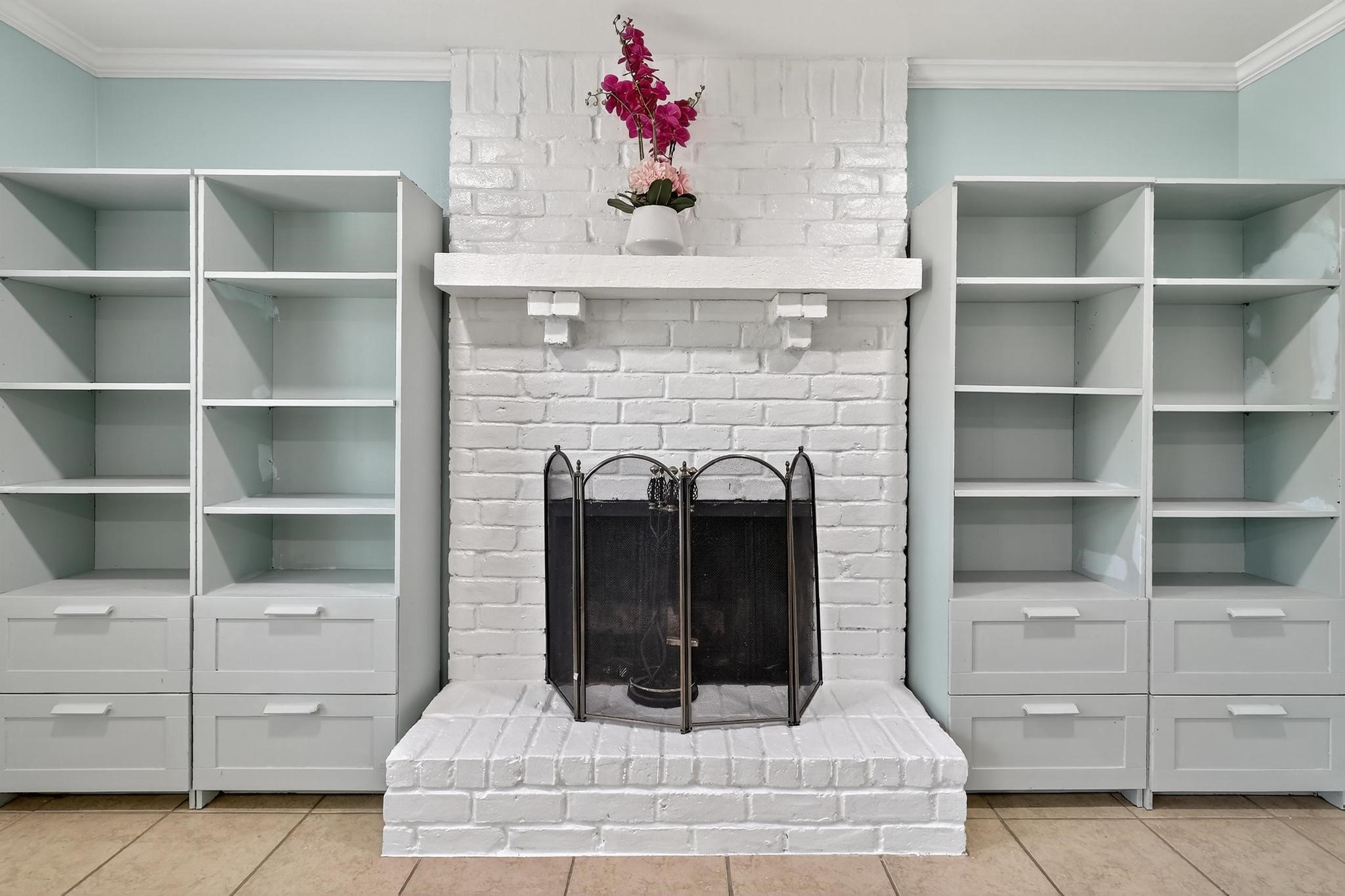 14418 Louetta Road Cypress, TX 77429 - Photo 24 of 39 a room with fireplace and cabinets