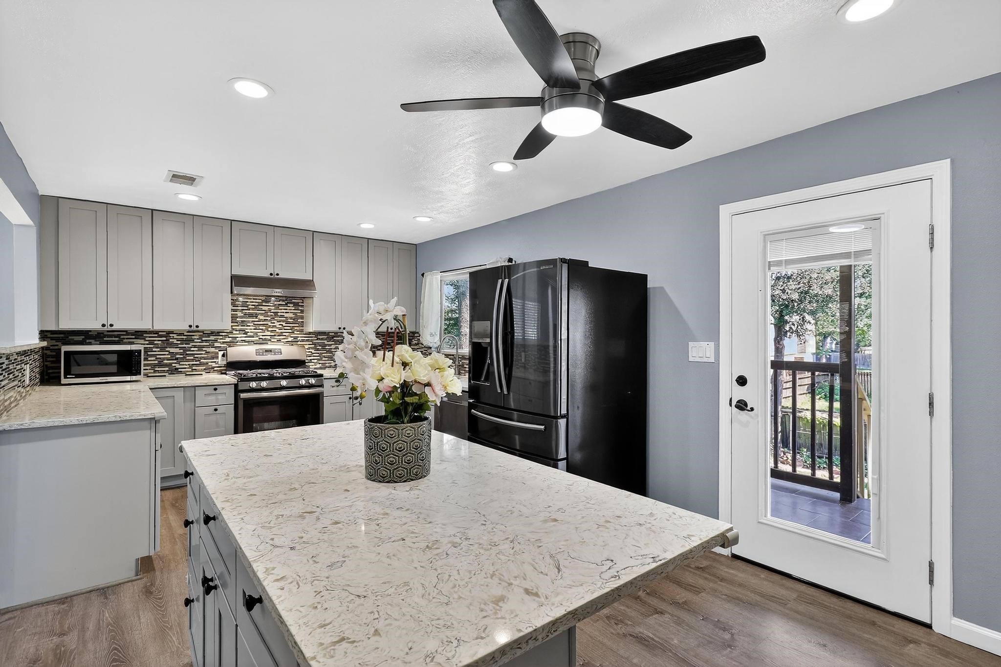 14418 Louetta Road Cypress, TX 77429 - Photo 5 of 39 a kitchen with a refrigerator a stove top oven a sink and dishwasher