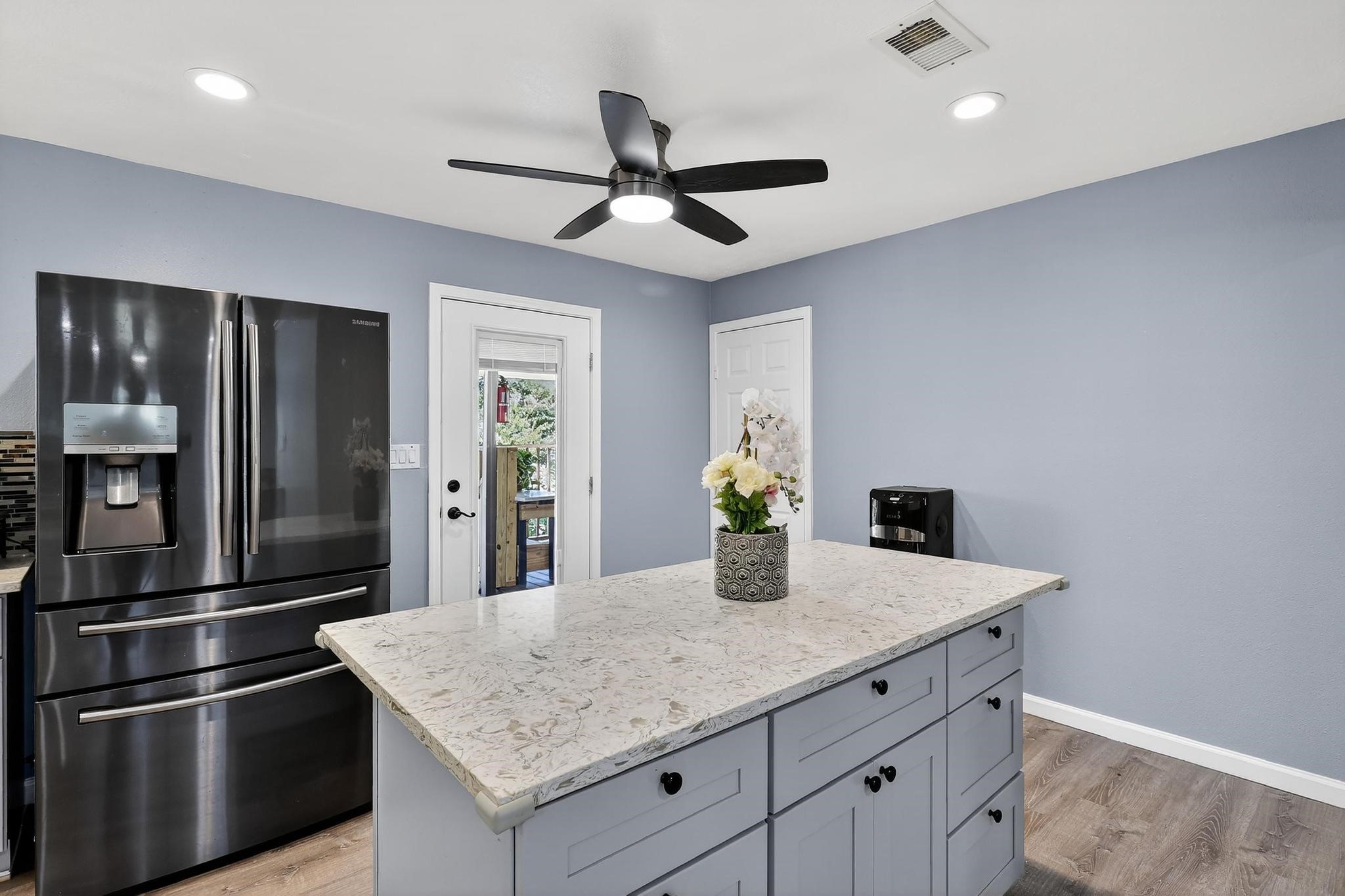 14418 Louetta Road Cypress, TX 77429 - Photo 8 of 39 a kitchen with granite countertop a refrigerator and microwave