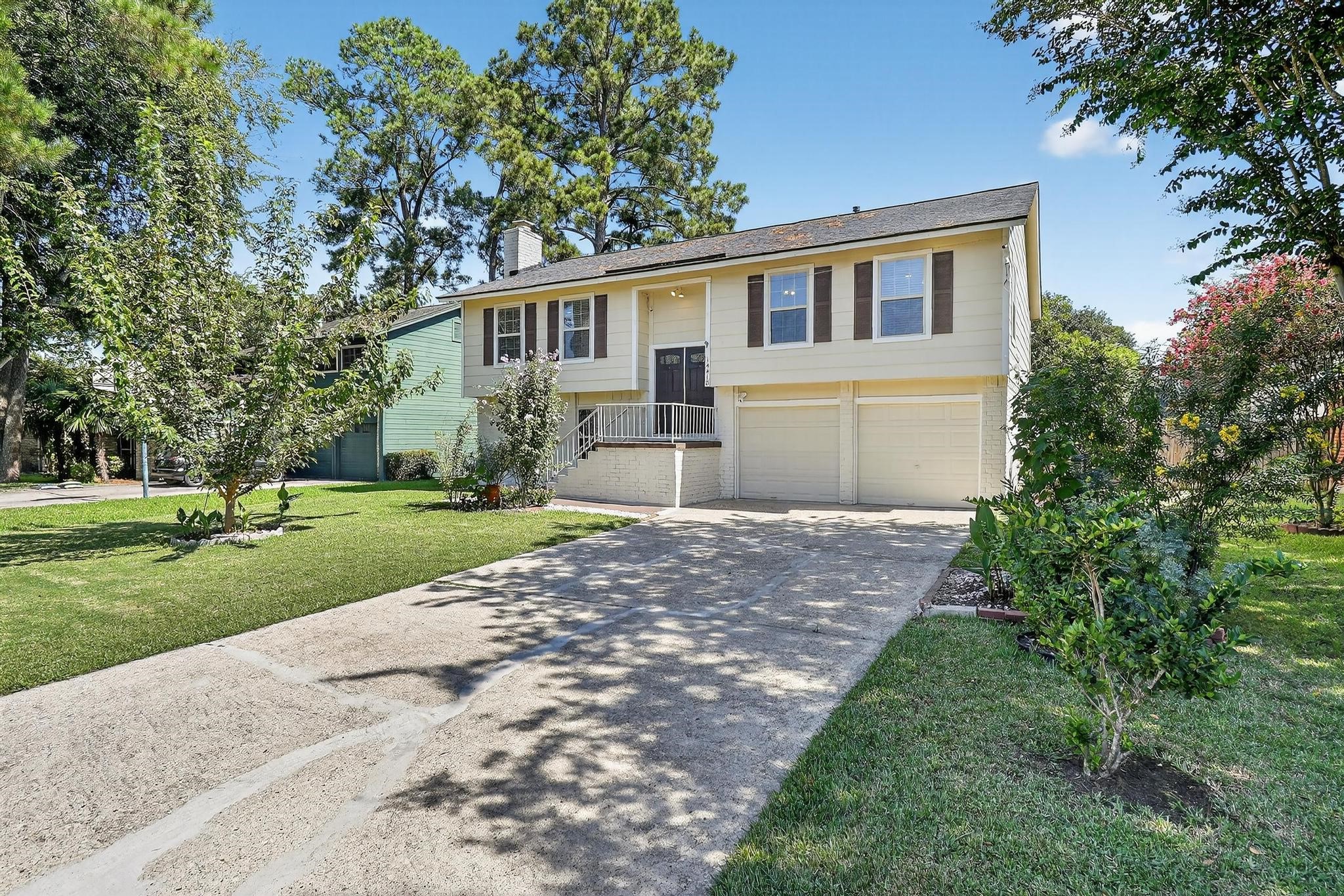 14418 Louetta Road Cypress, TX 77429 - Photo 10 of 39 a front view of a house with a yard and garage