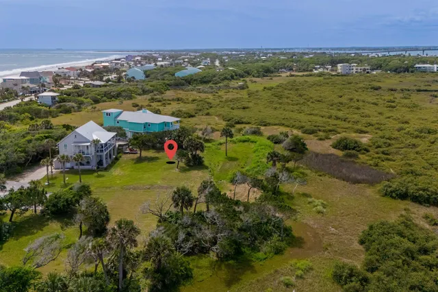 a view of a house with a yard and potted plants
