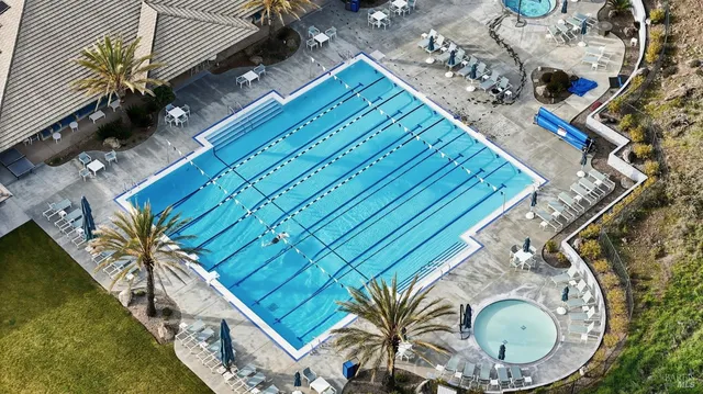 a house with a swimming pool and outdoor seating