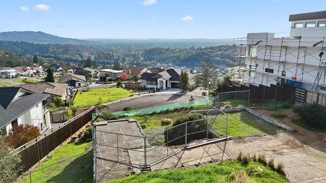 an aerial view of a house with a garden and mountain view